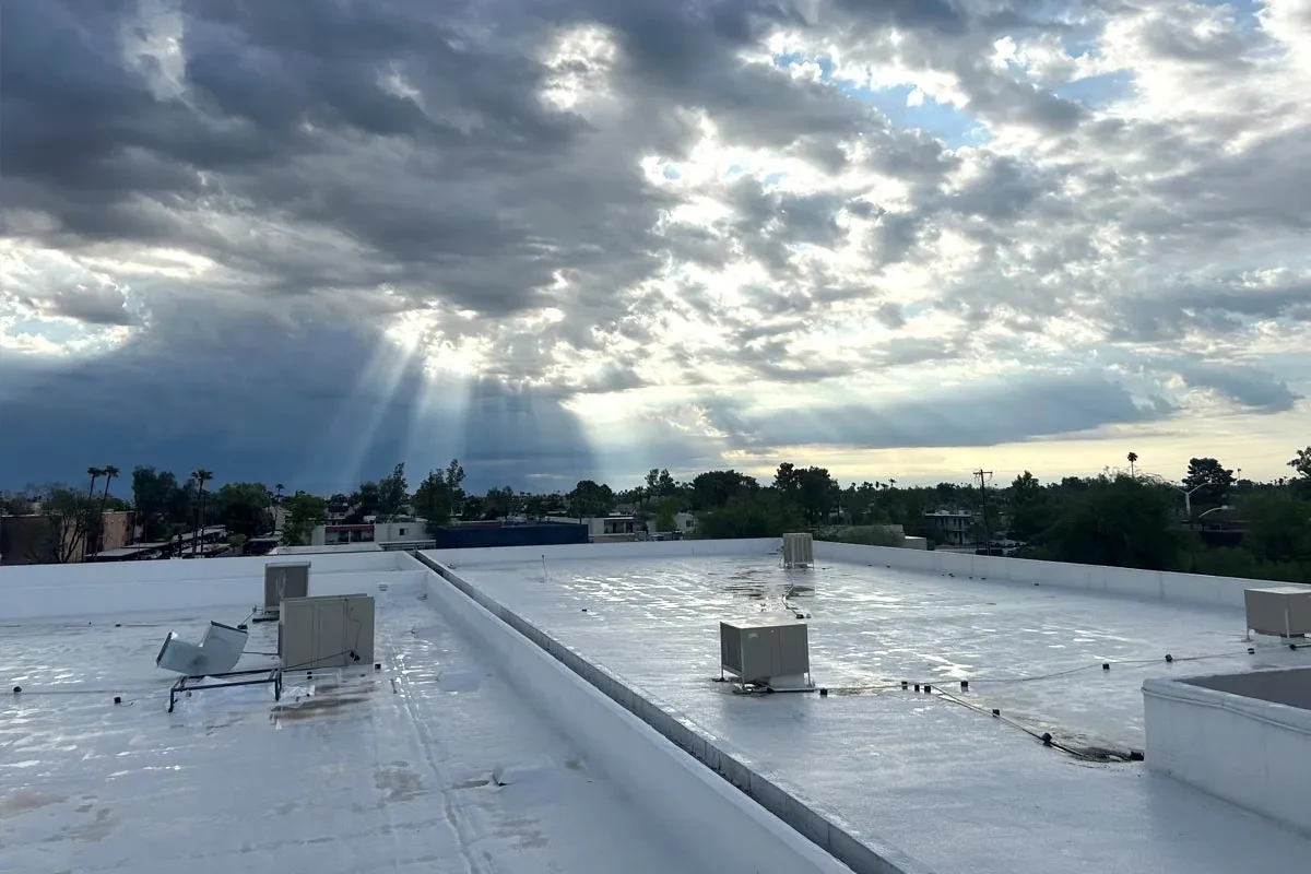 Pro-Tech reflective roof coating application on a low-slope roof