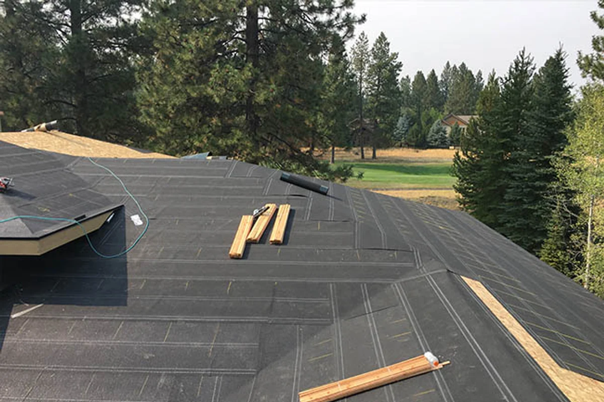 Roofing underlayment installed across a sloped roof deck by a Fontana contractor