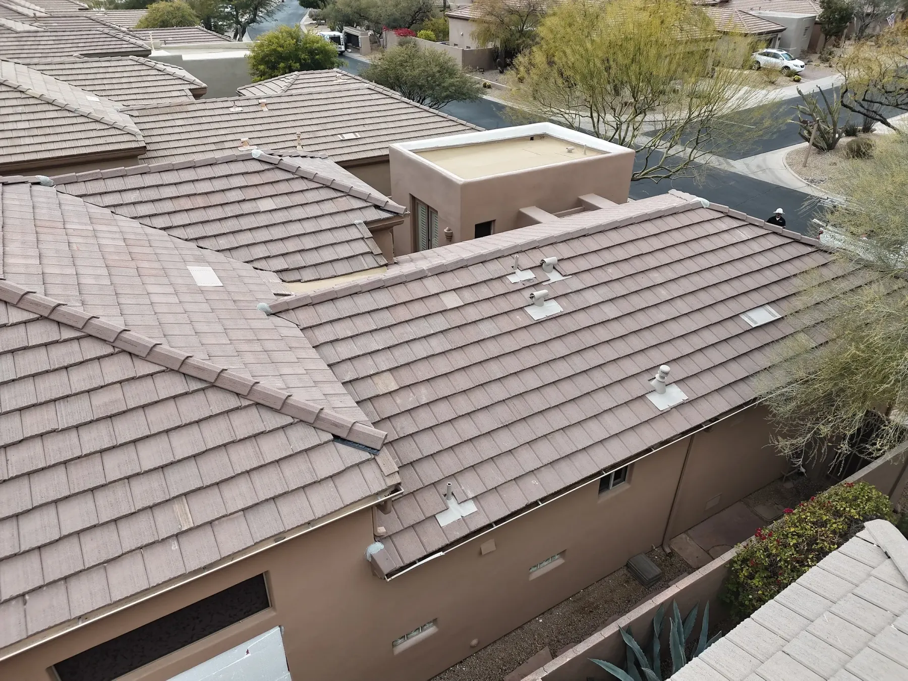 Close aerial view of completed gray tile roofing
