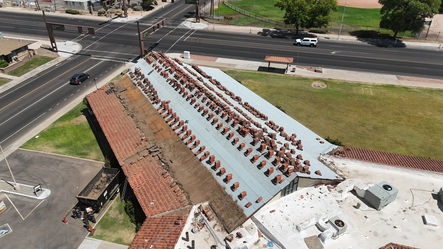 High oblique view of red tile roof with white underlayment and tiles arranged in rows