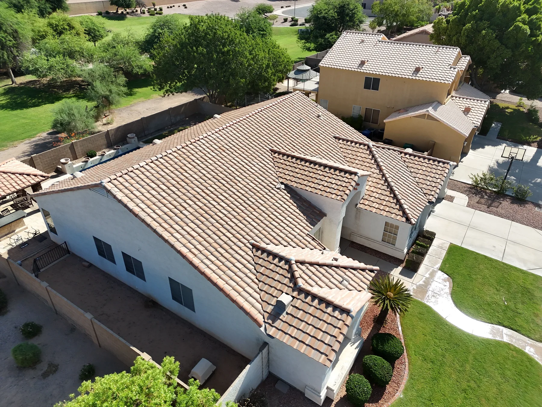 Aerial view of completed pale terracotta tile roof with intersecting hips and valleys