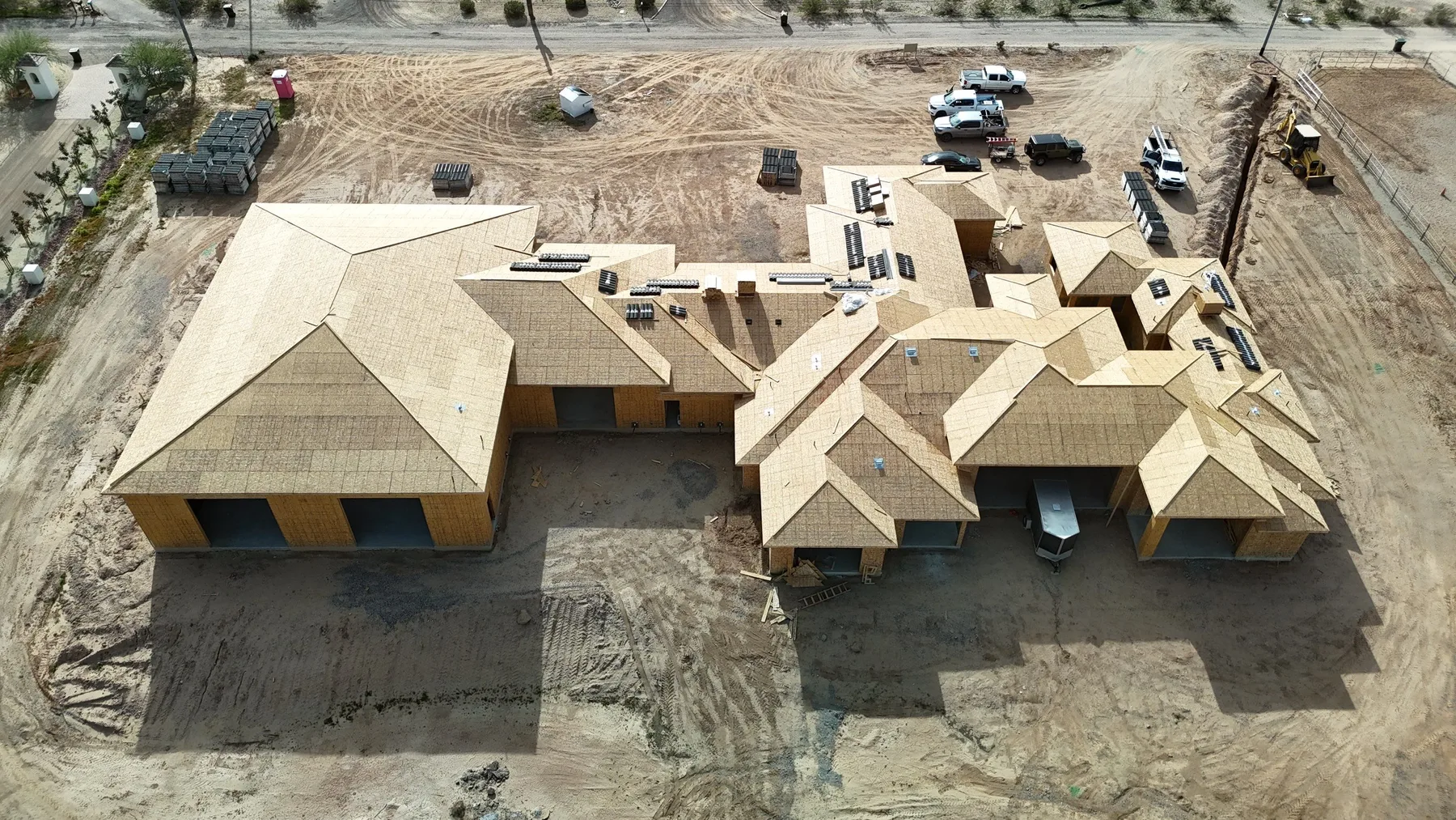 Aerial view of pale exposed wood decking across a sprawling multi-gabled house