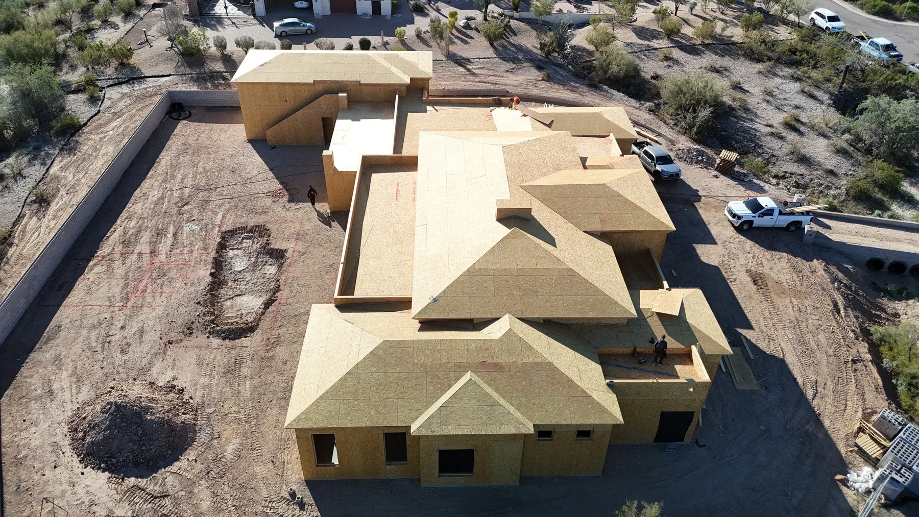 Aerial view of pale exposed wood decking covering a large multi-wing gabled structure