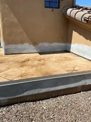 Angled view of tan coated walk deck with gray perimeter band and stucco walls