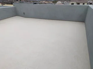 Wide elevated view of white flat deck enclosed by gray parapets